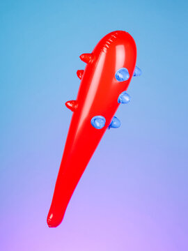 Close-up of an inflatable stick with a spiked inflatable club on a purple background, emphasizing its rugged and playful design.