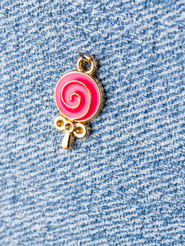 Close-up of a lollipop-shaped pendant for jewelry making, placed on a craft table.