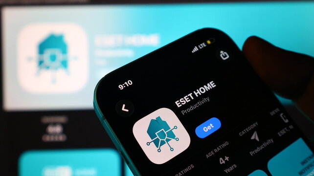 Smartphone held in hand displaying mobile application store page for eset home app store.