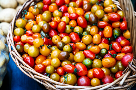Wicker basket filled with colorful cherry tomatoes