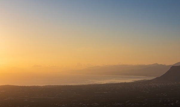 Panoramic high angle view of Malia coastline on Crete island, Greece from Mount Edheri at golden sunset.