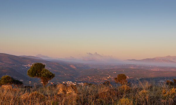 Scenic morning view from Mount Edheri over Gouves village on Crete, Greece with low fog and mist in the valley