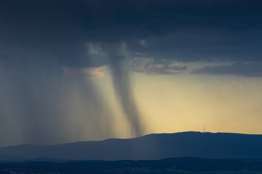 Close-up of a rain shaft and microburst over Klet mountain with transmitter during a summer storm
