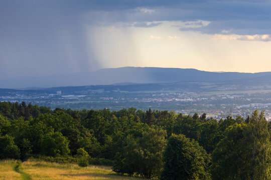 Panoramic view of Ceske Budejovice and Klet mountain with a distinct rain shaft in the background