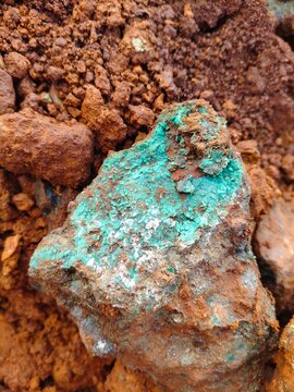 Raw nickel ore deposit with green silicate minerals and weathered iron oxide, sustainable resource for electric vehicle battery production