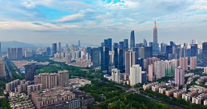 Aerial view of a sprawling urban skyline with iconic skyscrapers and residential areas in Shenzhen, China
