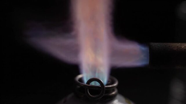 A close-up of different colored flame tests, illustrating chemical reactions and element identification for science education