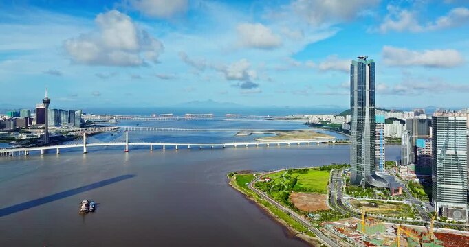 Aerial drone view of modern skyscrapers and cross-sea bridges in the coastal city skyline of Zhuhai and Macau, China