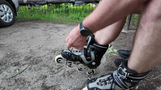 A passionate skater carefully laces up their rollerblades in a quiet park. Surrounded by nature and the warmth of the sun, the excitement builds for an exhilarating ride ahead.