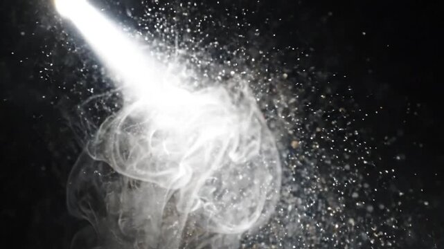 Macro of Tyndall scattering, a bright beam of light cutting through smoke and dust particles on a dark background