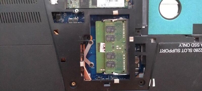 Laptop RAM memory module installed on motherboard inside computer casing