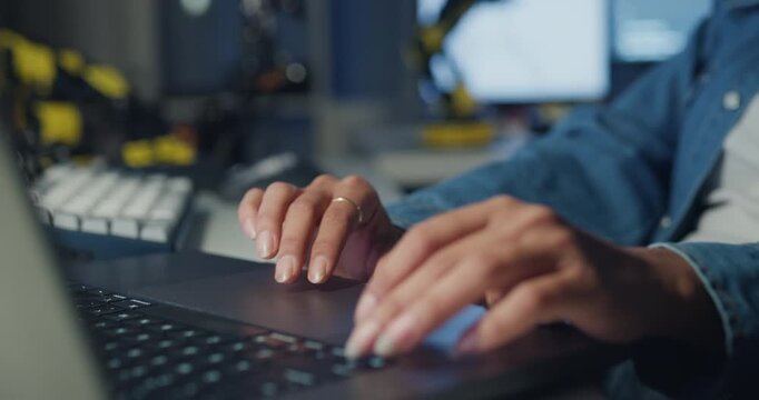 Close-up young Black female programmer coding AI software on multiple screens in night office. Network security, cybersecurity, machine learning, working late, overtime, robotics automation concept.