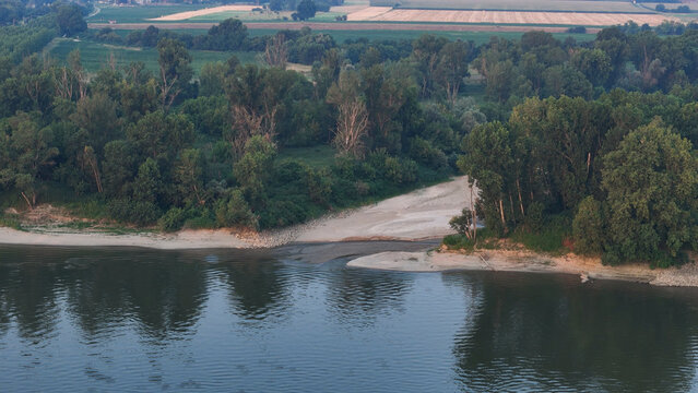 Po River experiencing extreme drought, displaying wide sand banks and exposed riverbed due to low water levels, impacting Lombardy and Emilia Romagna regions, Italy