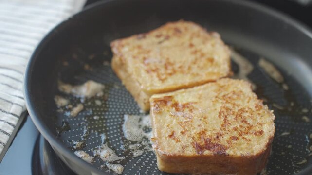 French toast fries in pan with melted butter, showing golden bread slices during breakfast cooking