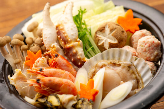 Luxurious seafood hot pot with crab, shrimp, and scallops for winter dining