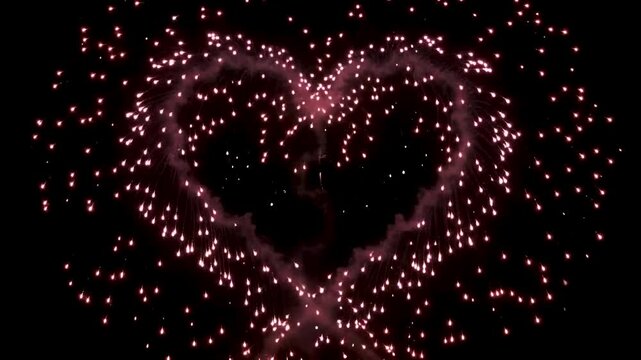Heart shaped fireworks display exploding in the dark night sky creating a beautiful romantic motion animation for special celebration video