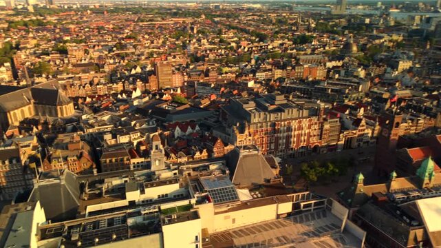 Drone panoramic sweep above Amsterdam historic center reveals rooftops and the Central Station area along the IJ waterway