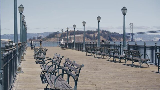 Pier Boardwalk Benches With Iron Lamp Posts On San Francisco Bay - Wide Shot