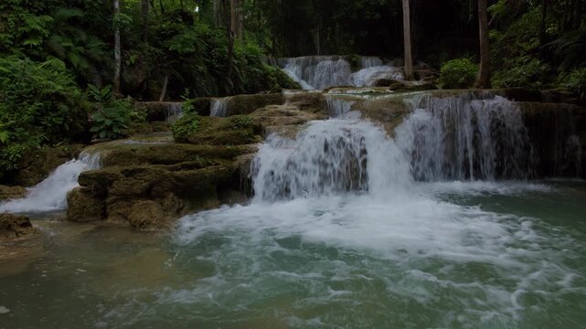 Cascading Tropical Waterfall Flowing Over Limestone Tiers In A Lush Green Rainforest At Huai Mea Khamin Waterfall Kanchanaburi Thailand