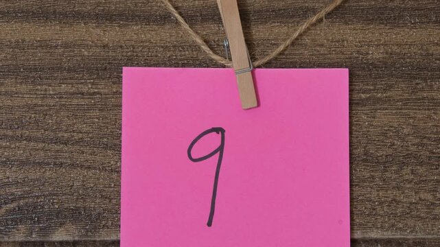Fuchsia Post-it note with the number nine