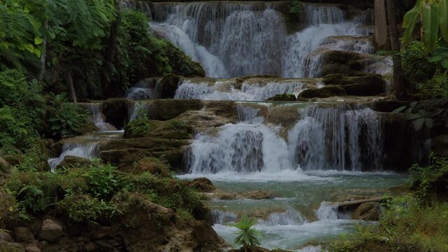 Cascading Tropical Waterfall Flowing Over Mossy Jungle Rocks In Huai Mea Khamin Waterfall Kanchanaburi Thailand