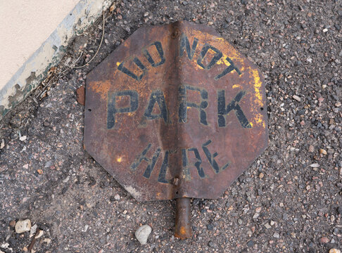 worn rusty no parking sign from an old industrial facility