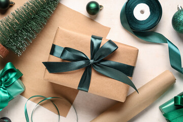 Fototapeta premium Christmas gift boxes with packing materials and decorations on white background