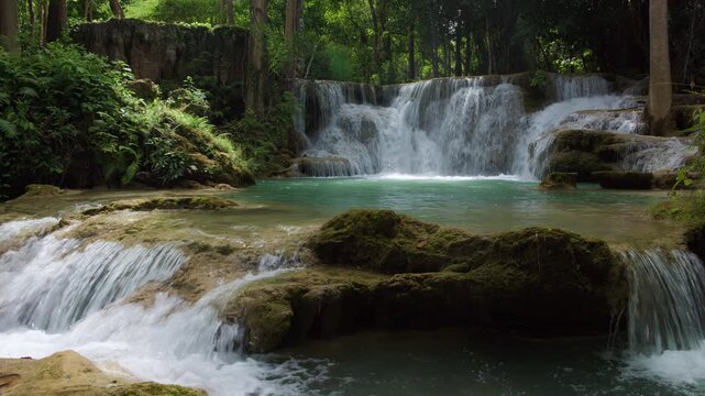 Cascading Turquoise Water Flows Over Limestone Rock Formations Amidst A Dense Tropical Rainforest At Huai Mea Khamin Waterfall Kanchanaburi Thailand