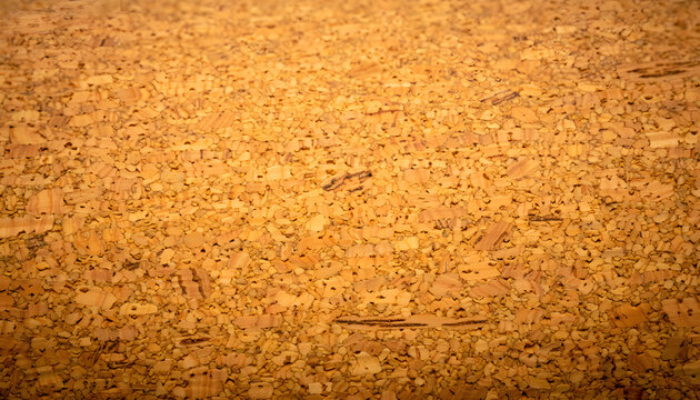 Close up macro photography of a natural brown cork board surface showing detailed organic patterns and porous texture for graphic backdrops