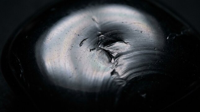 Black Obsidian Volcanic Rock Surface with Sharp Texture Details