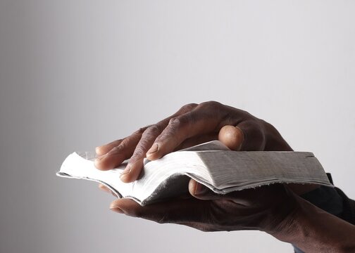 A serene portrait of a man praying with hands together in deep prayer that perfectly captures themes of faith, hope, mindfulness, and inner peace stock image stock photo