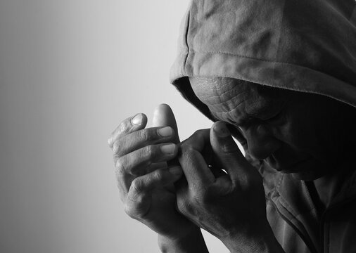 A serene portrait of a man praying with hands together in deep prayer that perfectly captures themes of faith, hope, mindfulness, and inner peace stock image stock photo