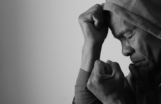 A serene portrait of a man praying with hands together in deep prayer that perfectly captures themes of faith, hope, mindfulness, and inner peace stock image stock photo