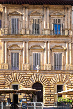 Historic Italian Palace Facade with Classical Columns and Tourist Restaurant on Ground Floor in Florence Italy