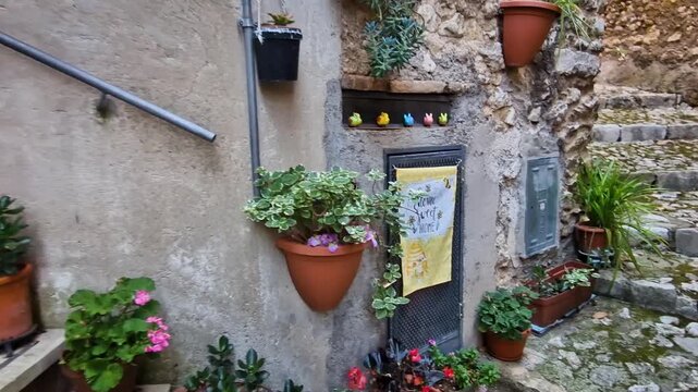 Cozy Details of Ancient Casperia Medieval Borgo Italy Handheld Cinematic Close-up Decorative Ceramic Rabbits Antique Coffee Pots, Flowers on Cobblestone Steps Authentic Italian Lifestyle Atmosphere 4K