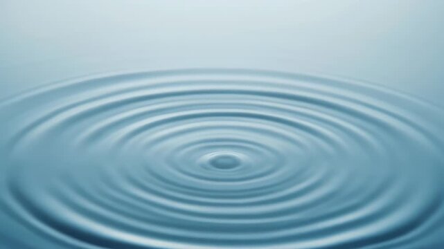 Blue water surface with gentle concentric ripples radiating outward from a central point, serene