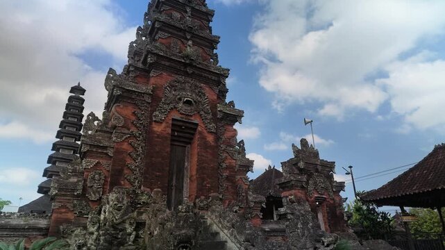 Traditional Balinese Hindu Temple Candi Bentar Gate with Red Brick and Stone Carvings