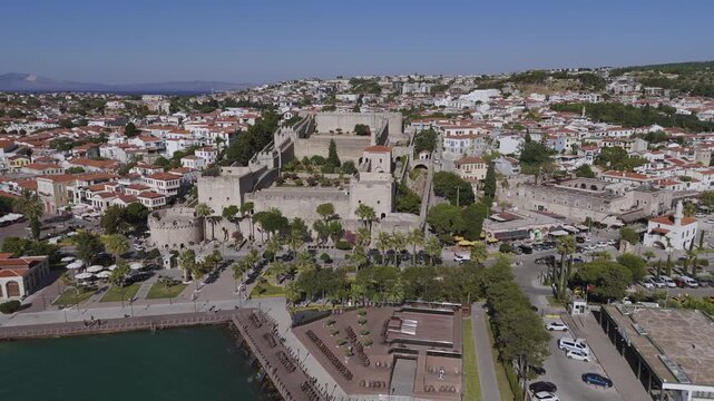 Aerial footage of Cesme Castle, and town centre of  Cesme, Turkey. &Ccedil;eşme is a seaside resort town and district on the tip of the Urla-Karaburun-&Ccedil;eşme Peninsula in Turkey's Aegean Region.