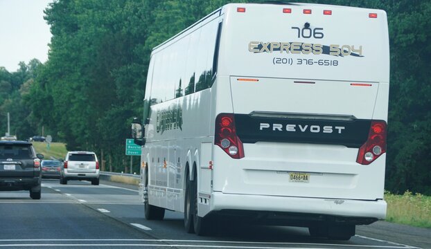 Southern Delaware, U.S.A - June 27, 2026 - A white Prevost Expres 504 passenger bus traveling on highway