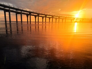 Fototapeta premium impressive huge bridge in the sunset sea horizon, fantastic sea horizon