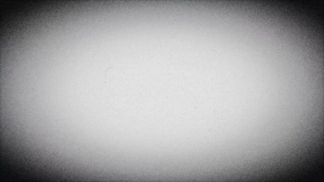 Vintage old film look background with heavy dust scratches and dark vignette frame effect loop black and white 4k video