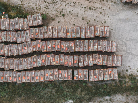 Aerial view of rows of stacked crab pots arranged on the ground in Unalaska, Alaska, United States.