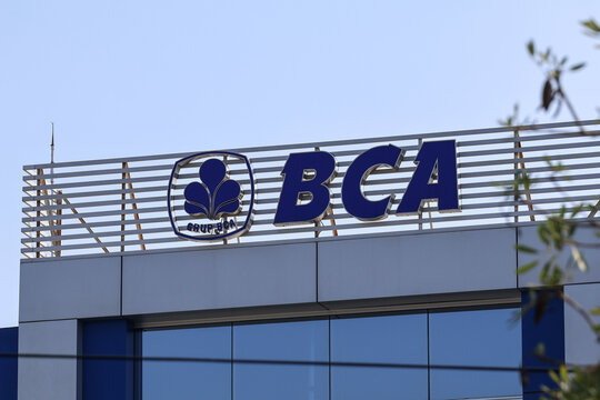 The official logo and building signage of Bank Central Asia (BCA), one of the largest private banks in Indonesia, mounted on top of a branch office building under a clear blue sky.