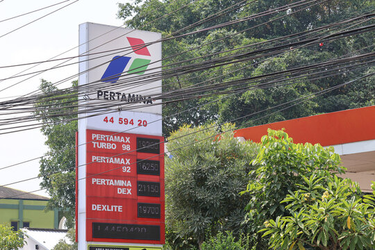 A close-up of a Pertamina gas station totem sign showing the company logo and fuel variant displays including Pertamax Turbo, Pertamax, Pertamina Dex, and Dexlite.