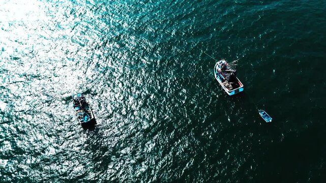 Top Down Drone View of Small Boats on Sparkling Ocean in Ecuador, Sunlit Water Texture, Coastal Fishing Fleet and Maritime Travel Background