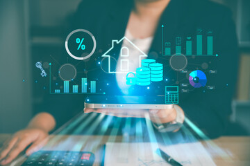 Obraz premium Business holding tablet with real estate finance hologram, house, coins, percent, charts and calculator, showing mortgage analytics, property investment, home loan planning and housing market growth.