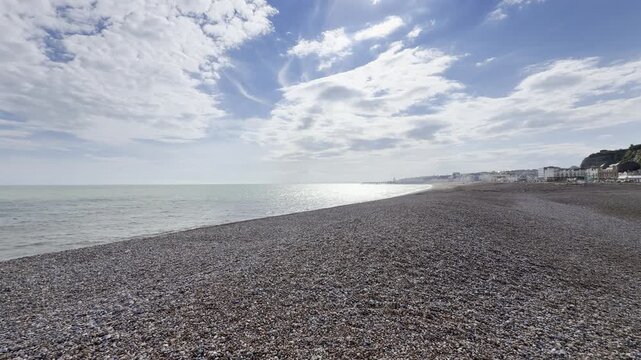 Wide shingle beach with distant town 4K