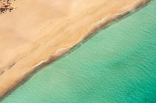 Aerial view of the turquoise waters and sandy shoreline of Detwah Lagoon, Qalansiyah wa Abd Al Kuri, Socotra, Yemen.