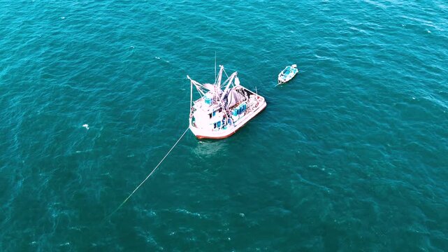 Top Down Drone View of White Fishing Boat Anchored on Turquoise Ocean in Ecuador, Rope Line, Coastal Maritime Detail and Seascape Background