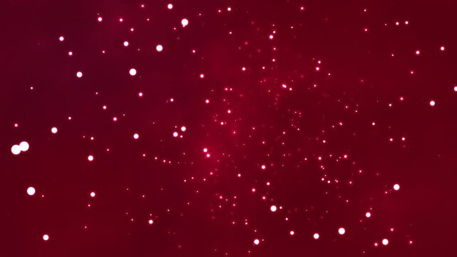 Glowing white particles drift gracefully across a deep red background in this smooth motion animation that captures a magical atmosphere filled with soft light and elegant floating bokeh effects.